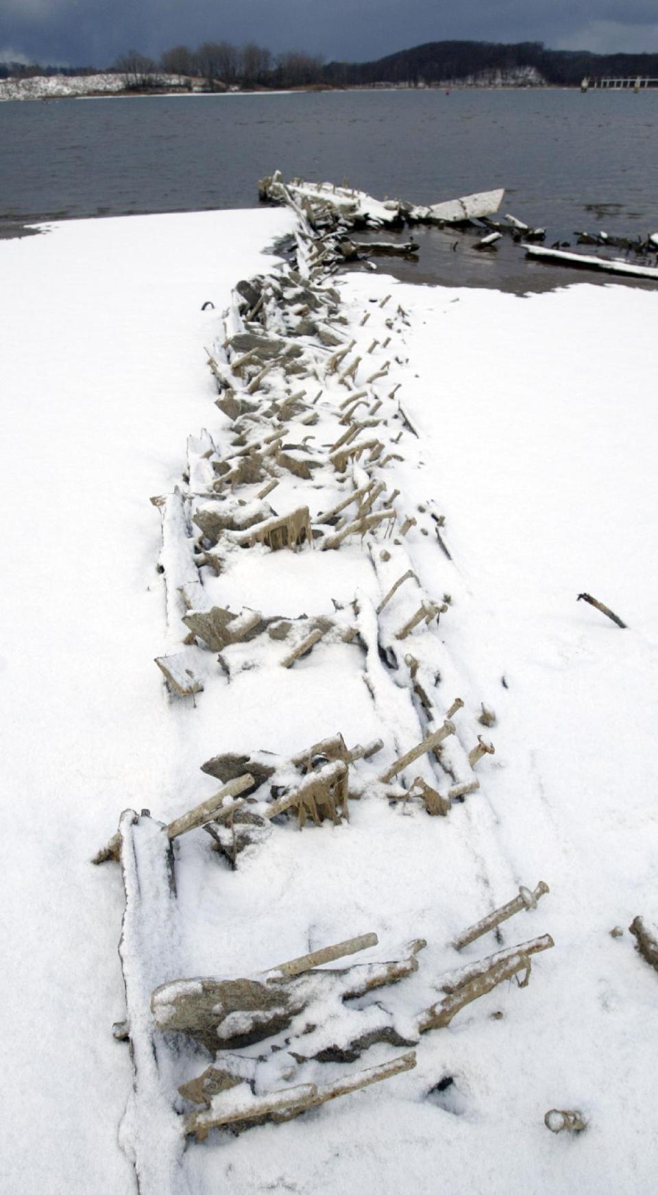 A section of the 290-foot shipwreck Aurora is exposed on Dec. 11, 2012 in Grand Haven, Mich. due to low water levels in the Grand River. The Aurora is in the Grand River, which flows into Lake Michigan nearby. Michigan Shipwreck Research Associates members and officials with the Tri-Cities Historical Museum in Grand Haven have surveyed the area. Valerie Van Heest, director of MSRA and a maritime historian, says this offers a rare chance to see wrecks without having to scuba dive. The Great Lakes are shrinking because of drought and rising temperatures. (AP Photo/The Muskegon Chronicle, Ken Stevens) ALL LOCAL TV OUT; LOCAL TV INTERNET OUT