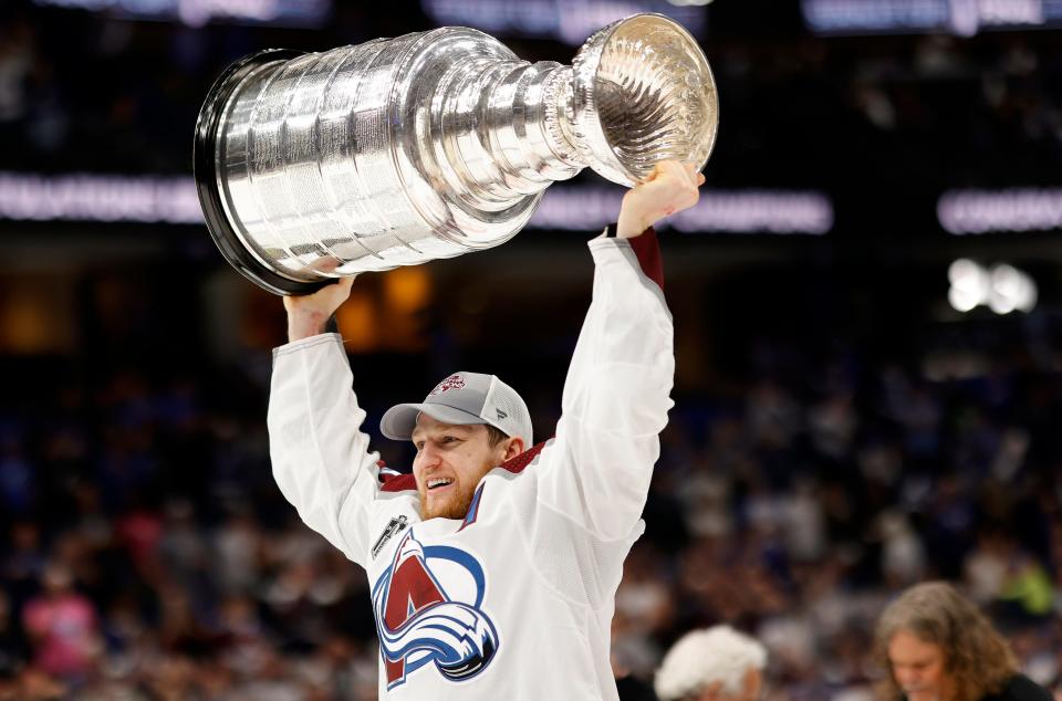 Nathan MacKinnon celebrates with the Stanley Cup.