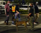 A security officer checks as fans arrive for an NCAA College Football Playoff national championship game between Alabama and Ohio State Monday, Jan. 11, 2021, in Miami Gardens, Fla. (AP Photo/Chris O'Meara)