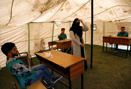 Afghan election workers wait for the residents at a voter registration centre for the upcoming parliamentary and district council elections in Kabul, Afghanistan April 23, 2018. REUTERS/Mohammad Ismail