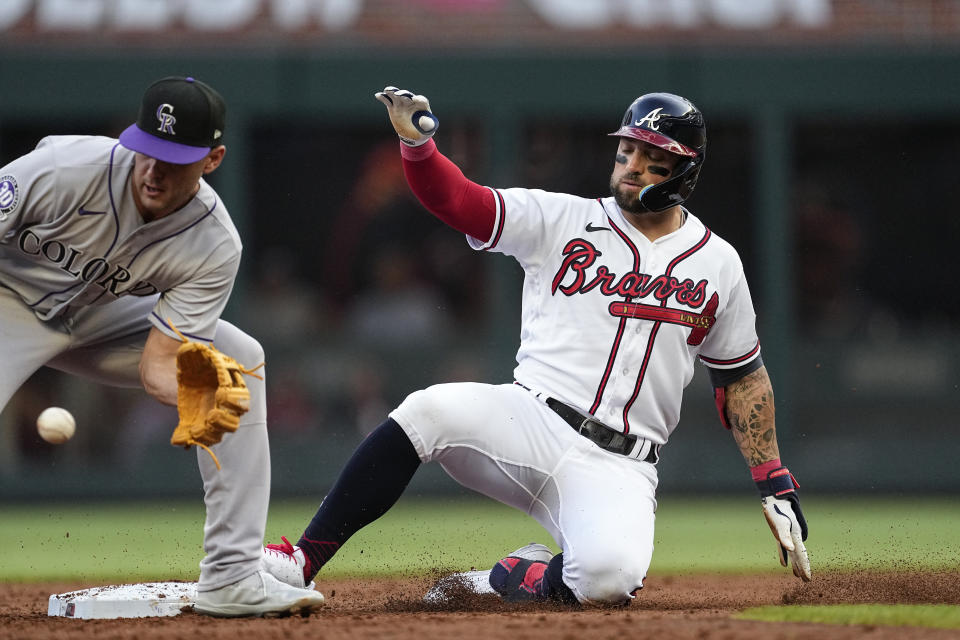 Atlanta Braves' Kevin Pillar slides into second base with a two-run double, while Colorado Rockies second baseman Coco Montes handles the late throw during the second inning of a baseball game Thursday, June 15, 2023, in Atlanta. (AP Photo/John Bazemore)