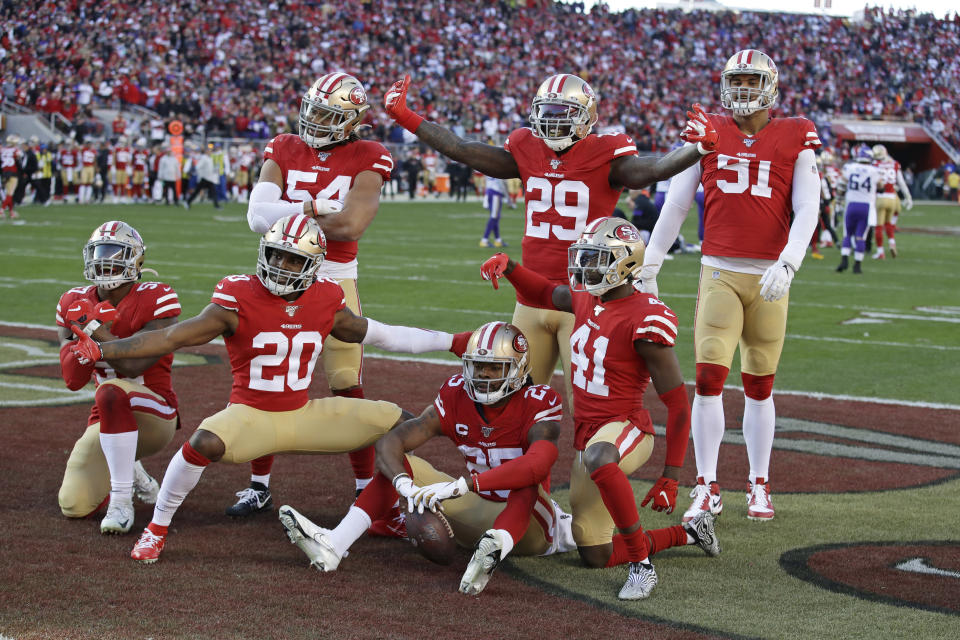 San Francisco 49ers players celebrate as a group after cornerback Richard Sherman (25), bottom center, intercepted a pass against the Minnesota Vikings during the second half of an NFL divisional playoff football game, Saturday, Jan. 11, 2020, in Santa Clara, Calif. (AP Photo/Marcio Jose Sanchez)