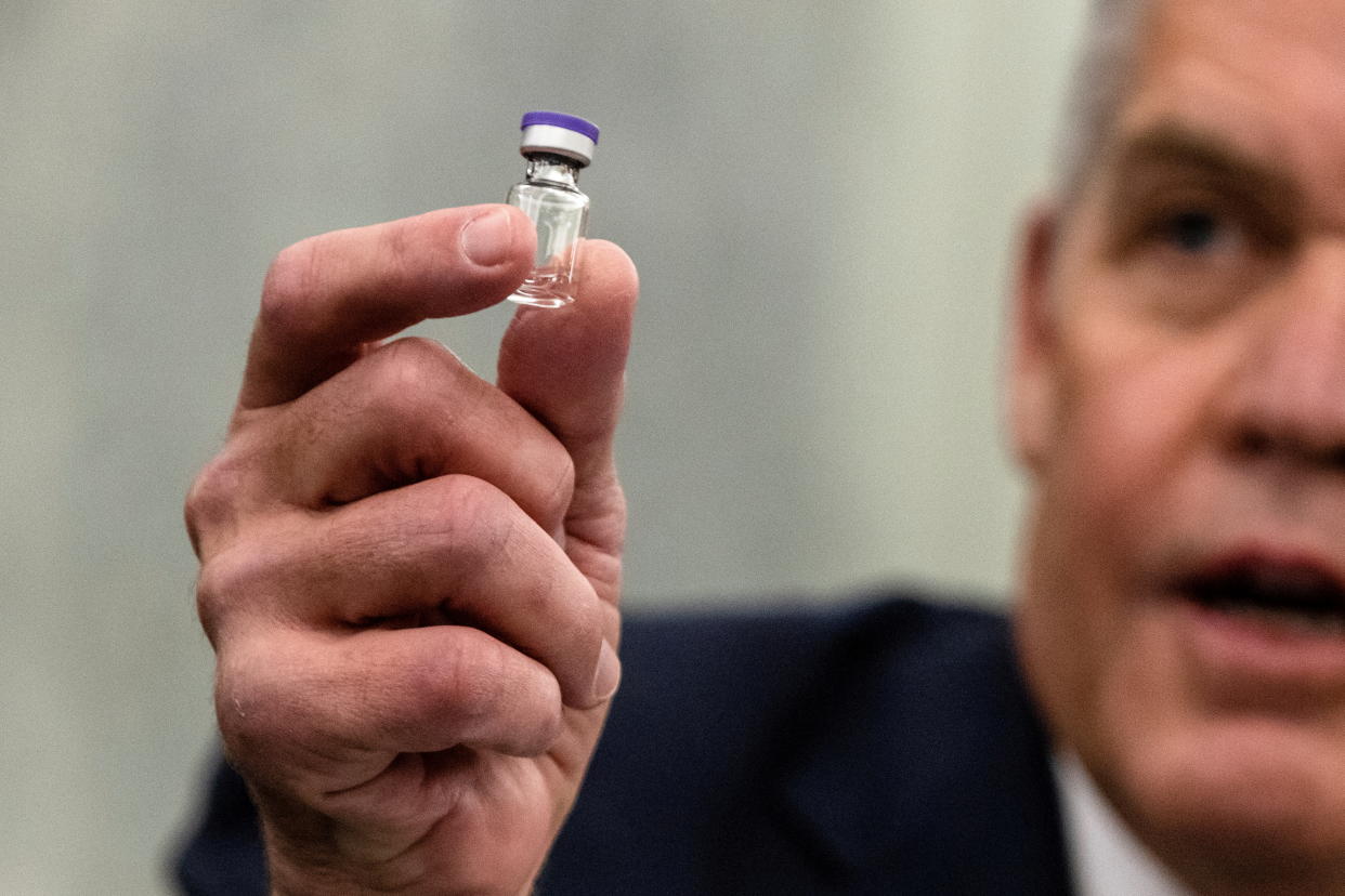 Wesley Wheeler, President of Global Healthcare at United Parcel Service (UPS) holds up an example of the Pfizer COVID-19 vaccine vial during a Senate Commerce, Science, and Transportation Subcommittee hearing on the logistics of transporting a coronavirus disease (COVID-19) vaccine on Capitol Hill, in Washington, D.C., U.S., December 10, 2020. Samuel Corum/Pool via REUTERS     TPX IMAGES OF THE DAY