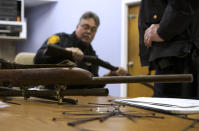 Bridgeport police officer Peter Garcia looks for a serial number on a rifle during a gun buyback event at the Bridgeport Police Department's Community Services Division in Bridgeport, Connecticut, in the wake of the shootings at Sandy Hook Elementary School, December 22, 2012. REUTERS/ Michelle McLoughlin (UNITED STATES - Tags: SOCIETY)