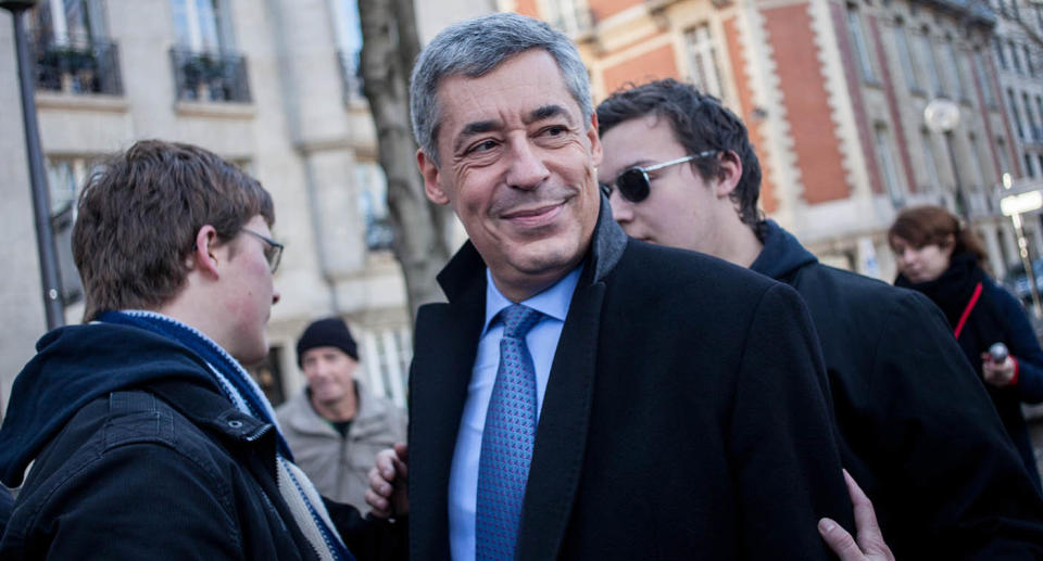 Henri Guaino stands on a street in Paris.