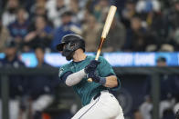 Seattle Mariners' Mitch Haniger watches his RBI single off Boston Red Sox starting pitcher Kutter Crawford during the first inning of a baseball game Saturday, March 30, 2024, in Seattle. (AP Photo/Stephen Brashear)