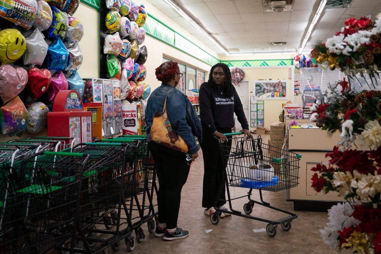 Vickie Brent-Touray, 52, of Pontiac, left, and her daughter Zoe Touray, 18, an Oxford High School graduate and founder of Survivors Embracing Eachother (S.E.E), shop for decorations for the Survivors United Play Day at Dollar Tree in Uvalde, Texas on Friday, Nov. 18, 2022.