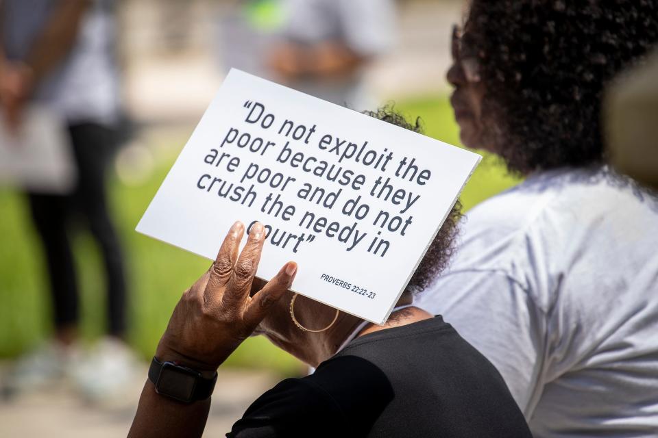 Demonstrators with the Polk Ecumenical Action Council for Empowerment (PEACE) held signs during Tuesday's event In Bartow emphasizing the negative effects of arrests for non-violent misdemeanors.