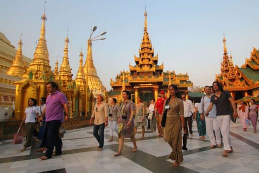 Tourists walk around the Shwedagon pagoda in Yangon. Last week, European Union nations put a halt to most sanctions against the impoverished nation for one year to reward a series of dramatic reforms since direct army rule ended last year