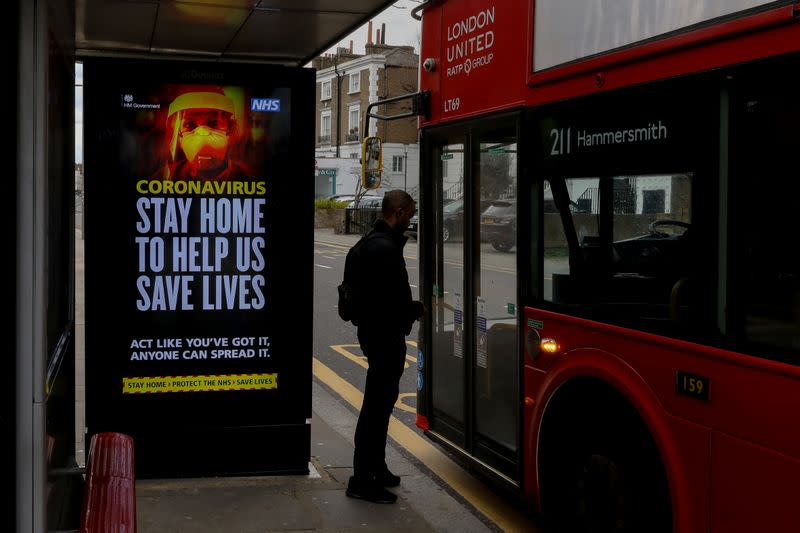 A UK government warning is seen at a bus stop in London