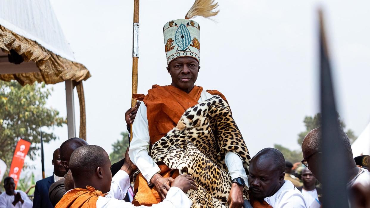 A man carries Kabaka (King) Ronald Muwenda Mutebi II on his shoulders during his 30 year coronation at his palace in Mengo, Kampala, on July 31, 2023.