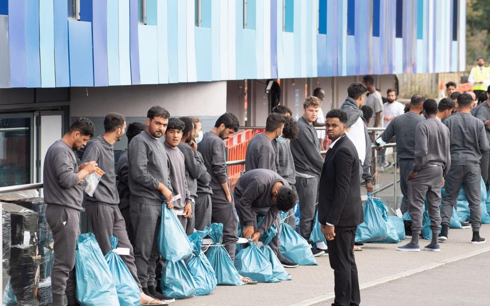 Asylum seekers at the Atrium Hotel in Feltham, London. The government is working to cut the use of hotels to house migrants