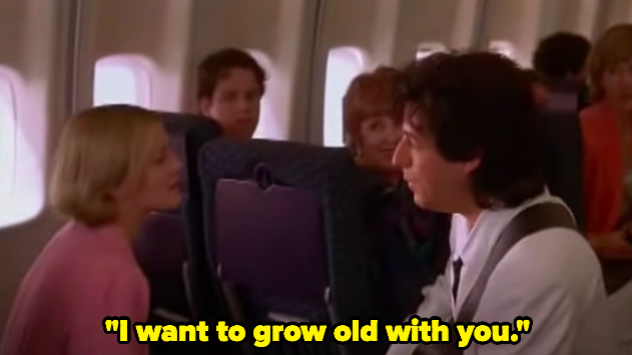 A man sings to a woman on a plane, saying "I want to grow old with you"