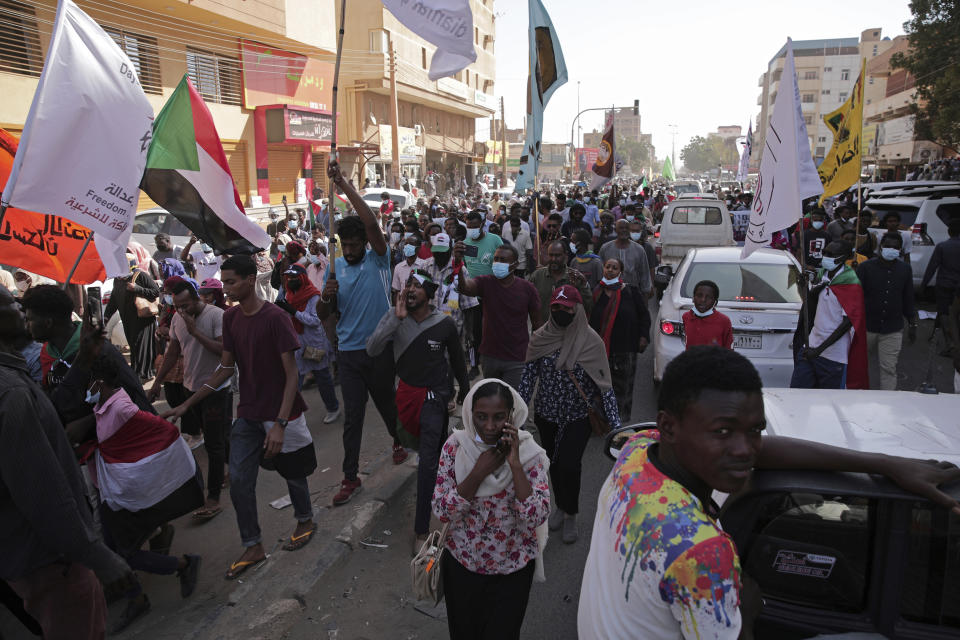 Tens of thousands calling for a civilian government march near the presidential palace in Khartoum, Sudan, Tuesday, Nov. 30, 2021. Security forces have fired tear gas at anti-coup protesters in the Sudanese capital on Tuesday, in the latest demonstrations against a military takeover that took place last month. (AP Photo/Marwan Ali)