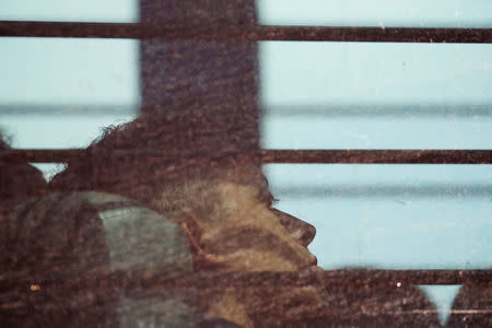 An undocumented immigrant sits on a bus with others before departing a U.S. federal court following hearings in McAllen, Texas, U.S., June 22, 2018. REUTERS/Loren Elliott