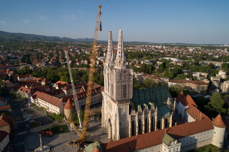 FILE PHOTO: A crane is holding the north tower of Zagreb's Cathedral during its removal, due to the threat of collapsing after being heavily damaged during the earthquake of March 22, in Zagreb