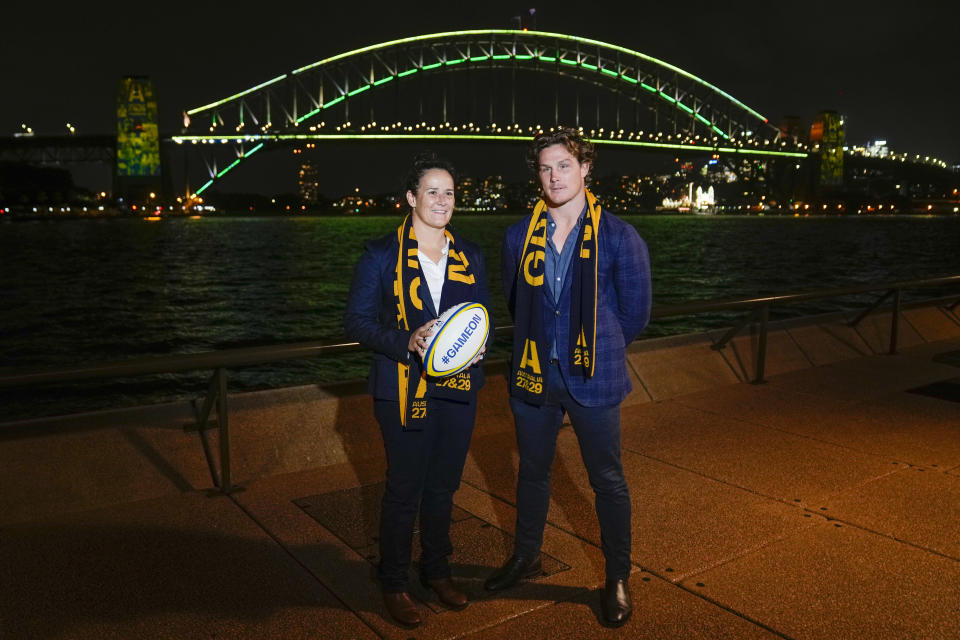 Wallabies captain Michael Hooper stands with Wallaroos captain Shannon Parry ahead of the final vote for the hosting of the Rugby World Cups in Sydney, Australia, Thursday, May 12, 2022. World Rugby will announce the host nations for the men's and women's World Cups for the period 2025-2033 with Australia heavily favored to host the men's 2027 and women's tournaments in 2029. (AP Photo/Mark Baker)