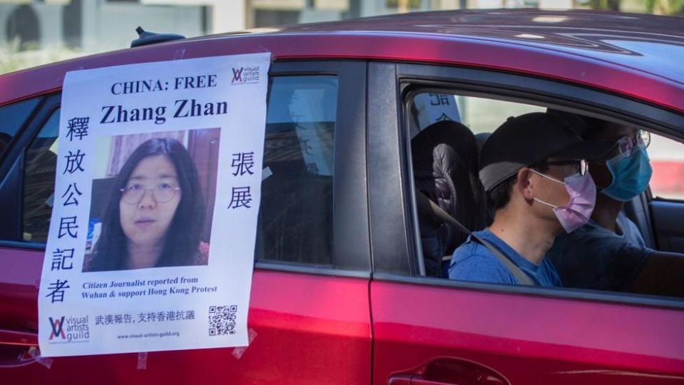 A car with a poster calling for the release of Zhang Zhan