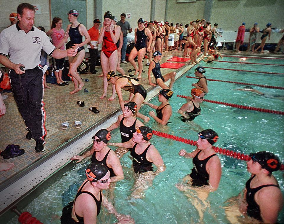 Coach Don Lemieux has a few last words for his Gardner High swimmers before the sectional championships in 2002.