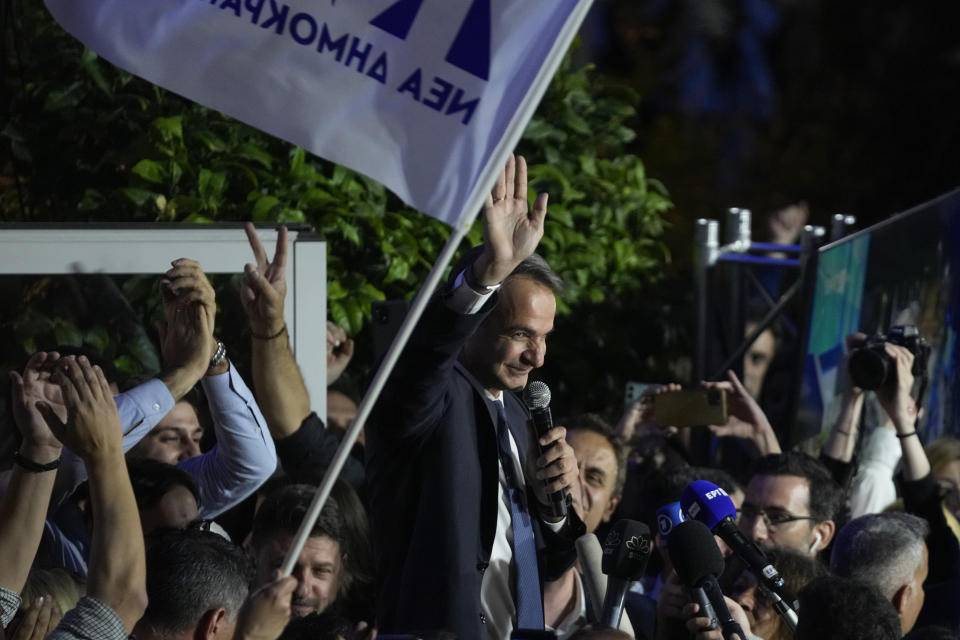 Greece's Prime Minister and leader of New Democracy Kyriakos Mitsotakis, center, addresses supporters at the headquarters of his party in Athens, Greece, Sunday, May 21, 2023. The conservative party of Greek Prime Minister Kyriakos Mitsotakis has won a landslide election but without enough parliamentary seats to form a government. (AP Photo/Thanassis Stavrakis)