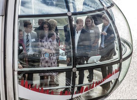 Britain's Princes' William and Harry, and Kate, The Duchess of Cambridge take a ride in a pod of the London Eye with members of the mental health charity "Heads together" on world mental health day in London, Britain October 10, 2016. REUTERS/Richard Pohle/Pool