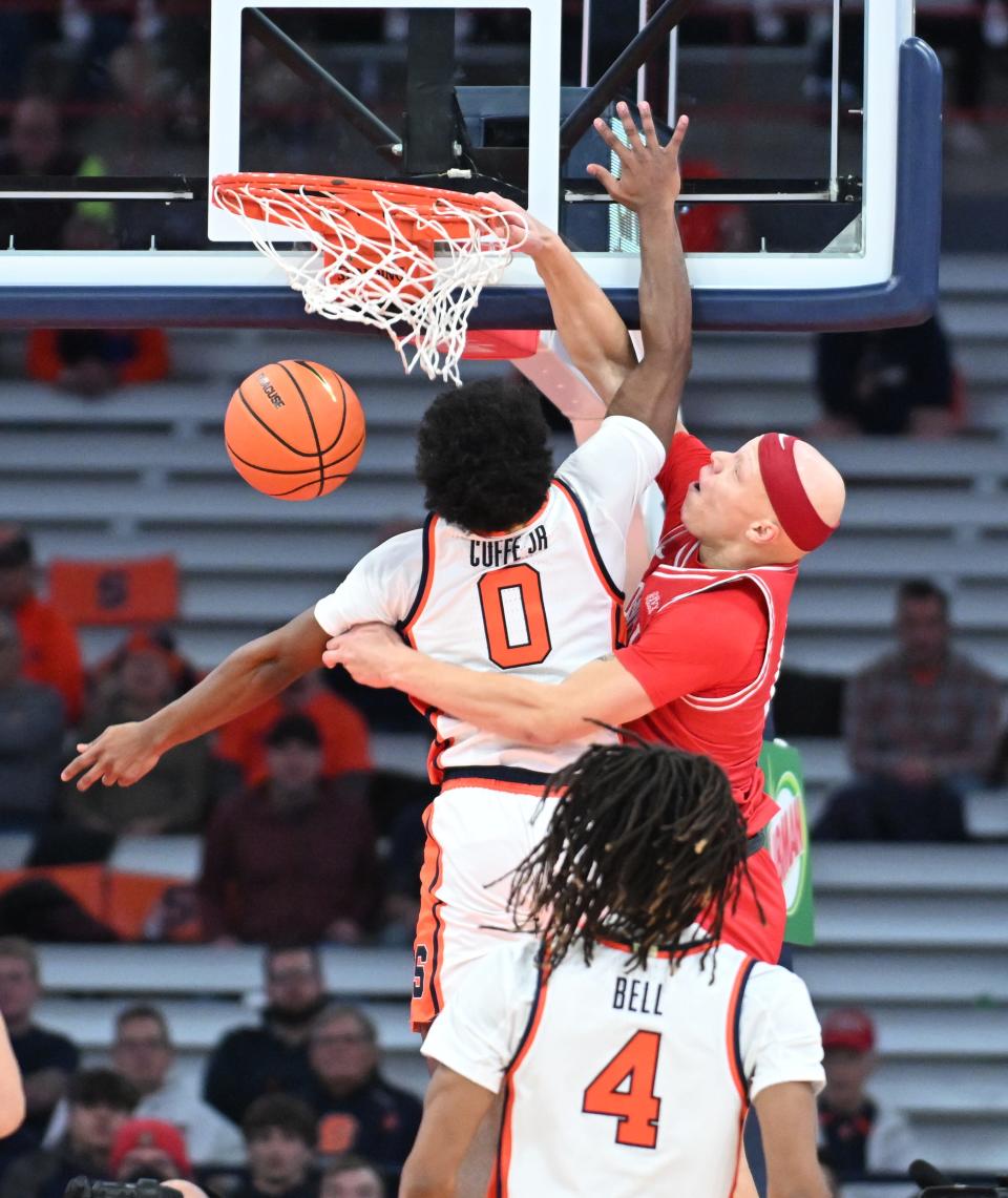 Cornell guard Isaiah Gray dunks the ball as Syracuse guard Kyle Cuffe Jr. defends on Dec. 5, 2023, at Syracuse.