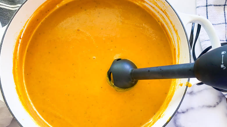 Immersion blender in pumpkin soup