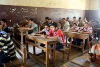 Students revise for a Koran verbal recital exam in one of the Al-Azhar institutes in Cairo, Egypt, May 20, 2015. REUTERS/Asmaa Waguih