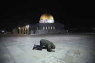 A muslim man pray next to the Dome of the Rock Mosque in the Al Aqsa Mosque compound in Jerusalem's old city, Sunday, May 31, 2020.The Al-Aqsa mosque in Jerusalem, the third holiest site in Islam, reopened early Sunday, following weeks of closure aimed at preventing the spread of the coronavirus. (AP Photo/Mahmoud Illean)