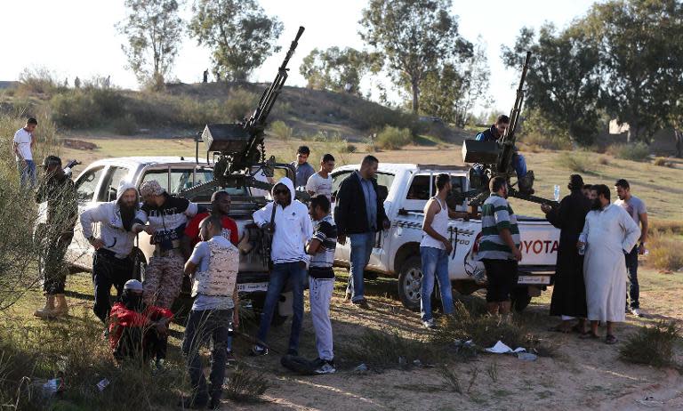 Members of the Tripoli Rebels Brigade militia patrol a main road in Tajura, 15 kms from the capital, on November 16, 2013