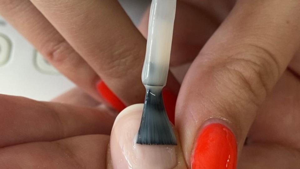 Fingernail with nude layer being applied 