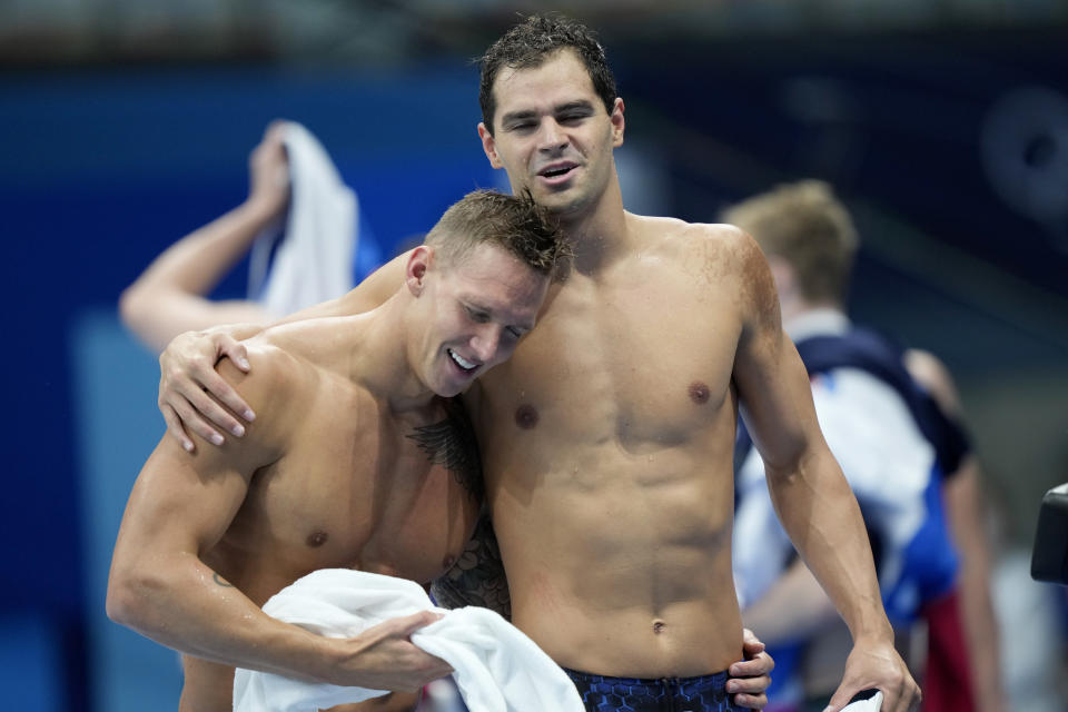 The United States' Caeleb Dressel, left, is embraced by teammate Michael Andrew after their team won the men's 4x100-meter medley relay at the 2020 Summer Olympics, Sunday, Aug. 1, 2021, in Tokyo, Japan. (AP Photo/David Goldman)
