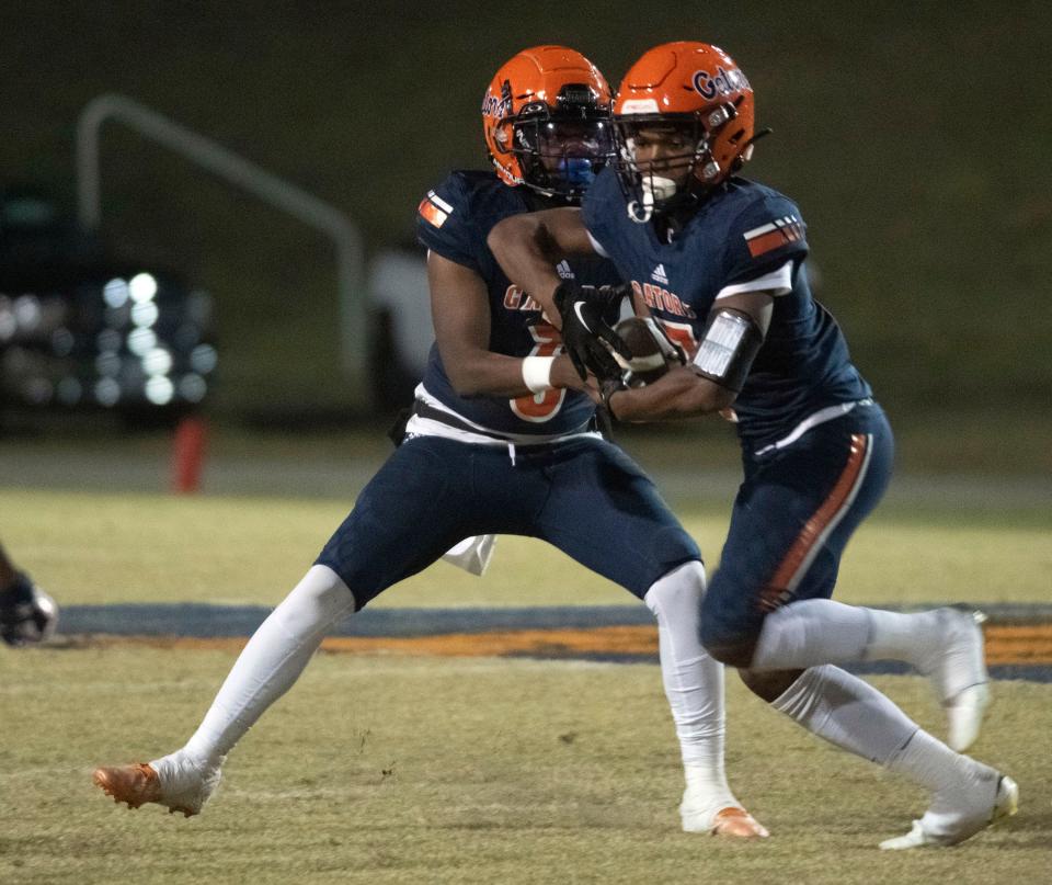 Escambia running back Keimani Turner (No. 7) takes the handoff from quarterback Ammiel Steele (No. 3) during Friday night's District 1-3S matchup against the Pine Forest Eagles.