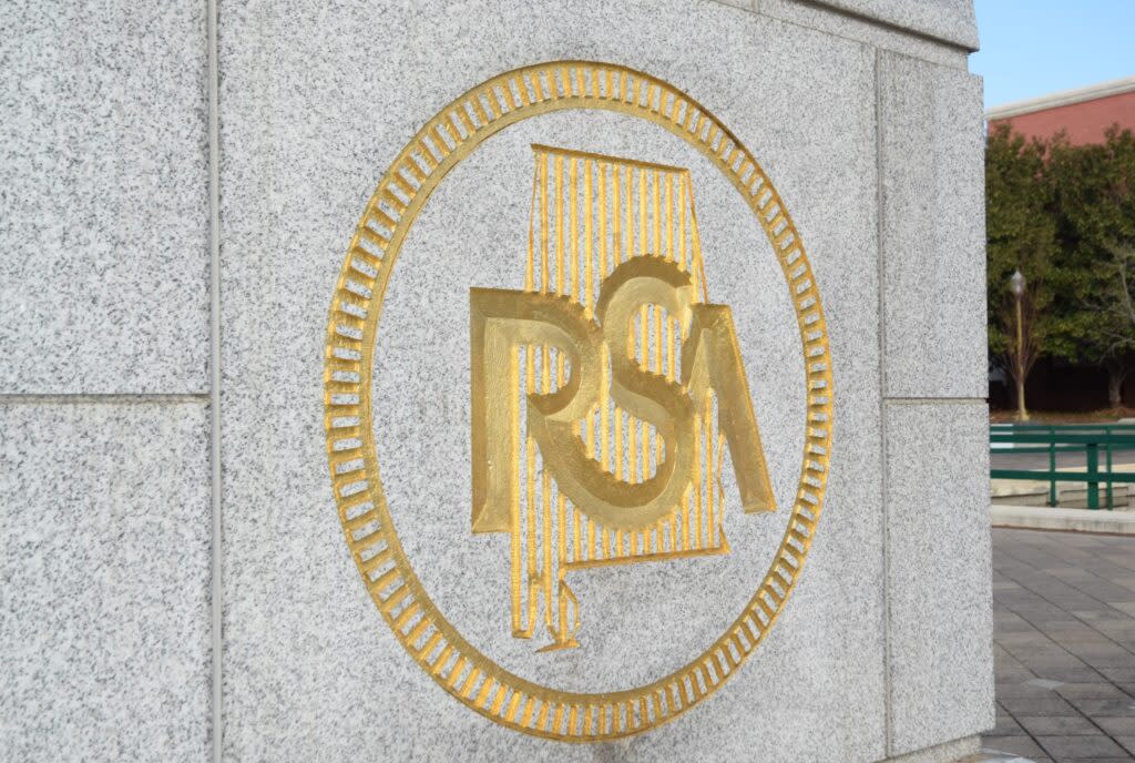 The logo of the Retirement Systems of Alabama features the letters RSA floating over an outline of Alabama in the center, surrounded by a circle. The logo is done in gold.