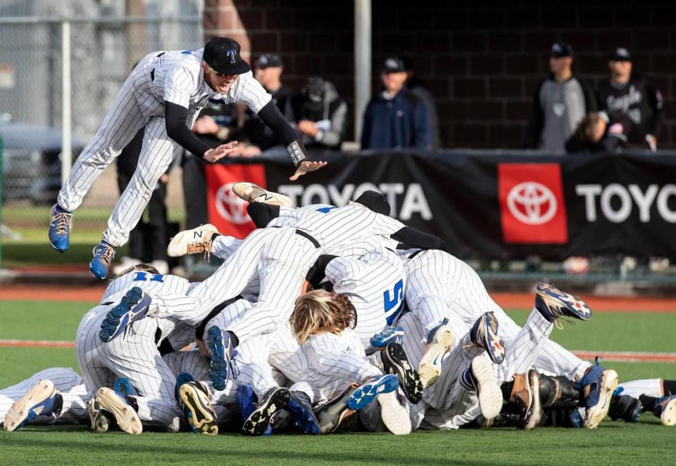 Timberline dog piles on top of pitcher Logan Miller after the final out of its 12-4 win over Eagle in the 5A baseball state championship game Saturday at Wolfe Field in Caldwell.