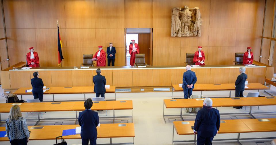 The judges of the German constitutional court (L-R) Ulrich Maidowski, Peter M. Huber, chairman Andreas Vosskuhle, Doris König and Christine Langenfeld arrive on May 5, 2020 at the Constitutional court in Karlsruhe, togive out their ruling that the European Central Bank must clarify a key bond-buying scheme to support the eurozone economy is "proportionate" or else Germany's Bundesbank central bank may no longer participate. - The Bundesbank will be barred from participating in the "quantitative easing" (QE) asset purchase programme in three months' time "unless the ECB Governing Council adopts a new decision that demonstrates in a comprehensible and substantiated manner that the monetary policy objectives pursued by the ECB are not disproportionate," the court said in a statement. (Photo by Sebastian Gollnow / dpa / AFP) (Photo by SEBASTIAN GOLLNOW/dpa/AFP via Getty Images)