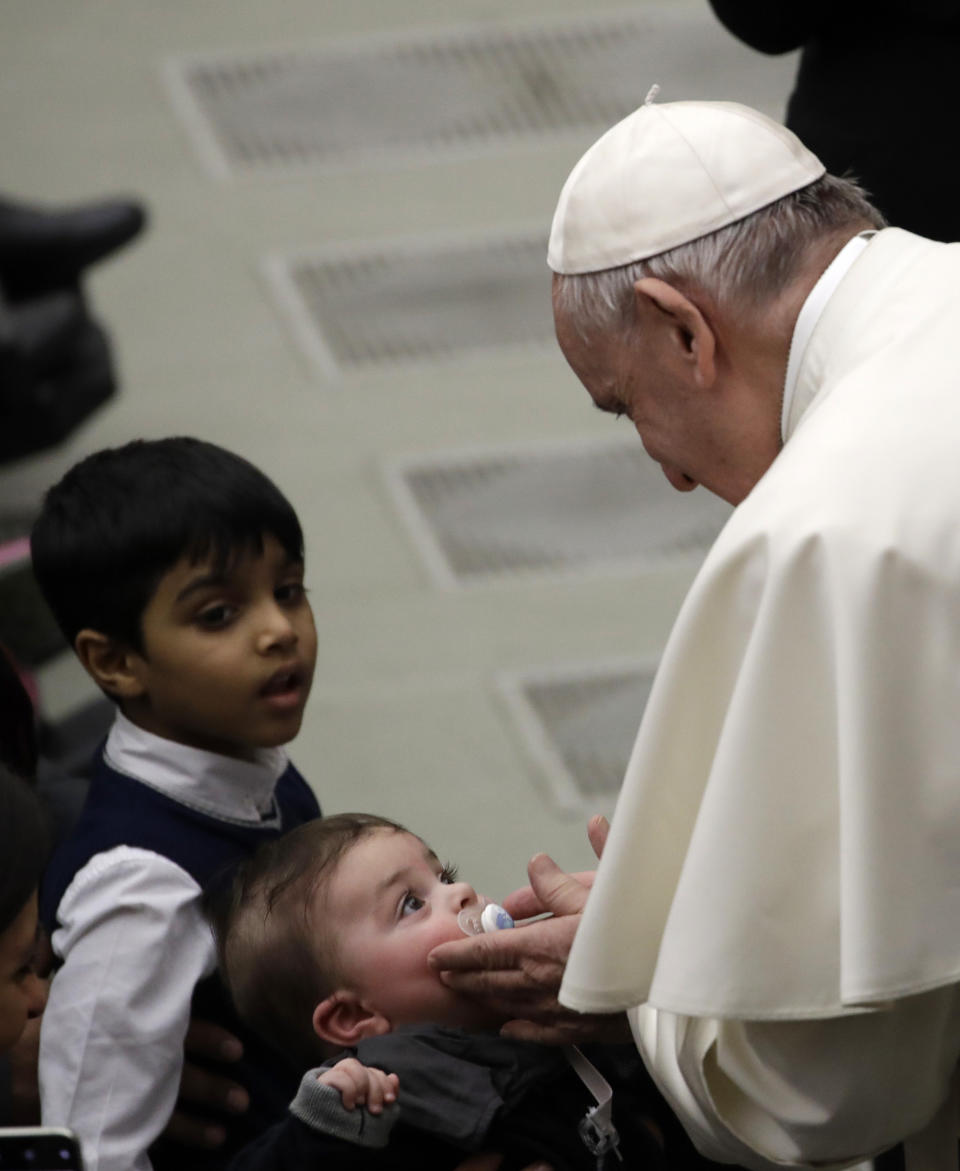 Pope Francis caresses a child during his weekly general audience in the Paul VI Hall at the Vatican Wednesday, Feb. 20, 2019. (AP Photo/Alessandra Tarantino)