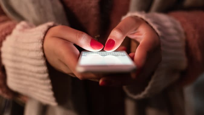 Close-up Image of Young Hipster Girl Using Modern Smartphone Device.