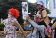 People march in Tokyo's Shinjuku shopping district Sunday, July 18, 2021, to protest against the Tokyo Olympics starting from July 23. They held signs that said No Olympics.(AP Photo/Yuri Kageyama)