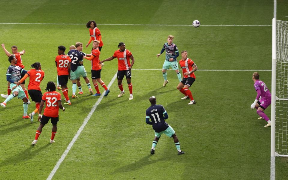 Ethan Pinnock of Brentford scores the third goal for his team during the Premier League match at Luton Town