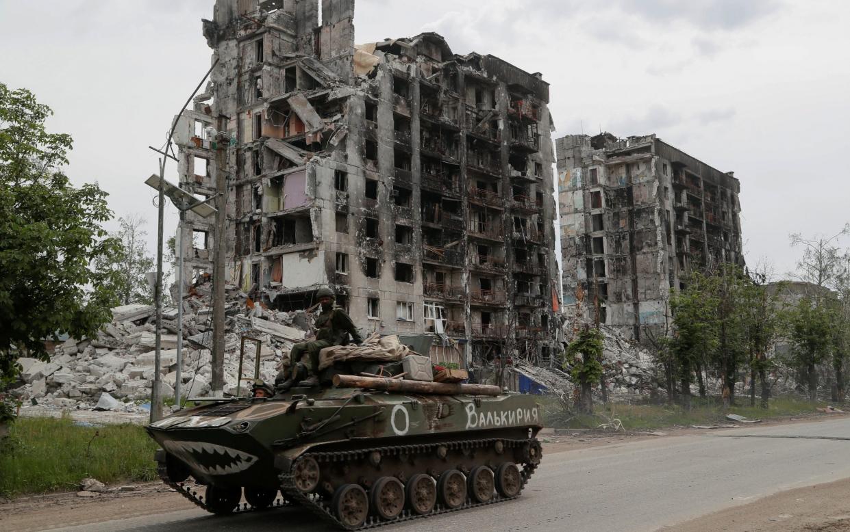 Service members of pro-Russian troops drive an armoured vehicle through Popasna, where a fresh atrocity is claimed to have been committed - ALEXANDER ERMOCHENKO /REUTERS