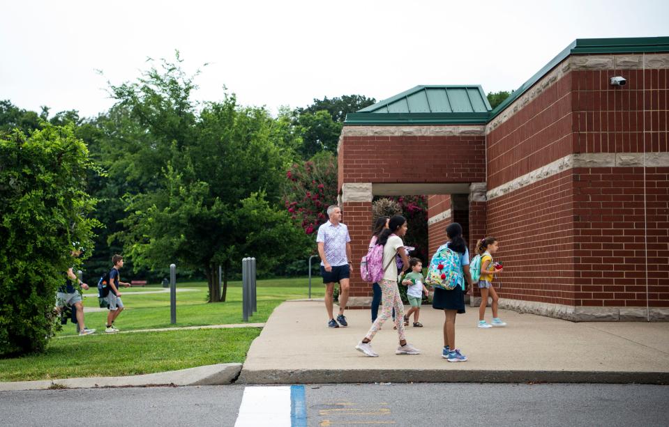 Students walk across the street on the first day of school at Kenrose Elementary School on Aug. 4, 2023, in Brentwood, Tenn.