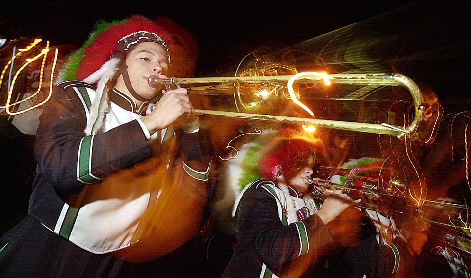 Trombonist Sam Durvin and the rest of the Choctawhatchee High School Stylemarchers provide festive music as they march down Eglin Parkway during the Christmas parade on Dec. 4, 2000. Daily News/DEVON RAVINE.