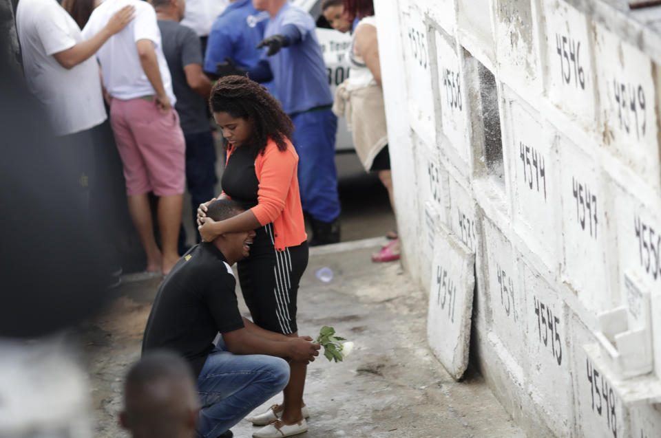 The uncle of the late 8-year-old Ágatha Sales Felix cries during her burial at the cemetery in Rio de Janeiro, Brazil, Sunday, Sept. 22, 2019. Félix was hit by a stray bullet Friday amid what police said was shootout with suspected criminals. However, residents say there was no shootout, and blame police. (AP Photo/Silvia Izquierdo)