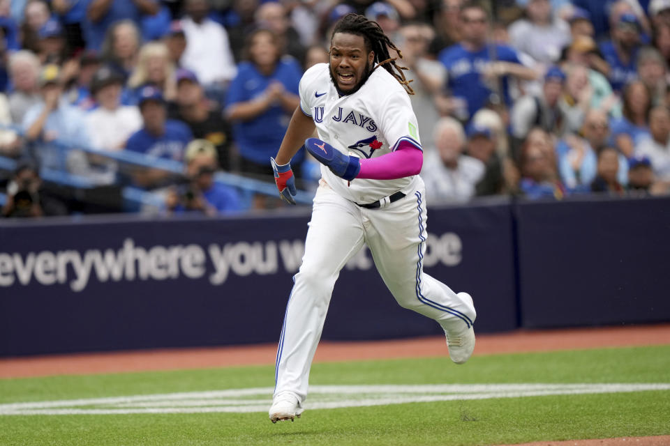 Toronto Blue Jays first baseman Vladimir Guerrero Jr. (27) runs to home plate to score a run during the sixth inning of a baseball game against the Kansas City Royals in Toronto, Saturday, Sept. 9, 2023. (Nathan Denette/The Canadian Press via AP)