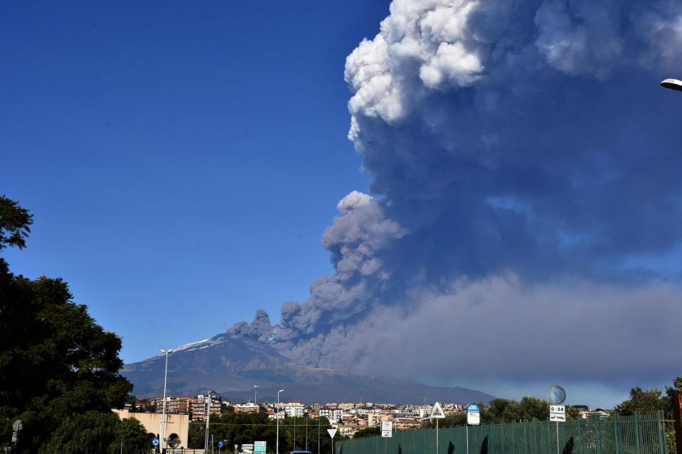 A smoke column comes out of the Etna volcano in Catania, Italy, Monday, Dec. 24, 2018. The Mount Etna observatory says lava and ash are spewing from a new fracture on the active Sicilian volcano amid an unusually high level of seismic activity. (Orietta Scardino/ANSA via AP)