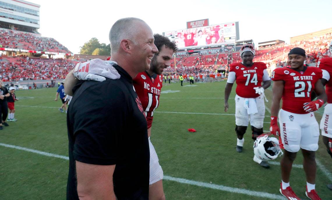 N.C. State head coach Dave Doeren walks off the field with linebacker Payton Wilson (11) after the Wolfpack’s 24-17 victory over Clemson at Carter-Finley Stadium in Raleigh, N.C., Saturday, Oct. 28, 2023. Ethan Hyman/ehyman@newsobserver.com