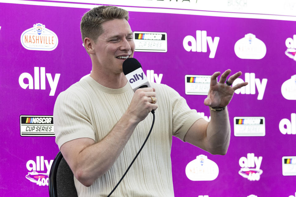 Two-time Indianapolis 500 winner Josef Newgarden speaks to reporters before a NASCAR Cup Series auto race, Sunday, June 30, 2024, in Gladeville, Tenn. (AP Photo/Wade Payne)