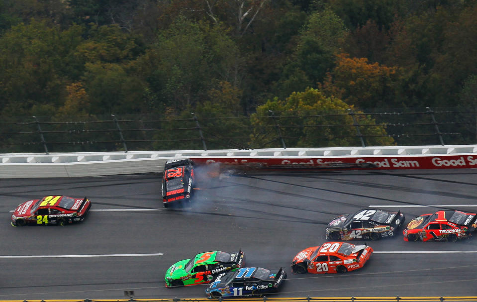 TALLADEGA, AL - OCTOBER 23: Regan Smith, driver of the #78 Furniture Row Companies Chevrolet, crashes as Mark Martin, driver of the #5 GoDaddy.com Chevrolet, and Denny Hamlin, driver of the #11 FedEx Office Toyota, make contact during the NASCAR Sprint Cup Series Good Sam Club 500 at Talladega Superspeedway on October 23, 2011 in Talladega, Alabama. (Photo by Kevin C. Cox/Getty Images for NASCAR)