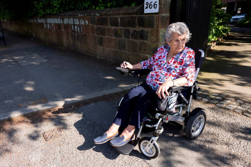 Sybil Turner unable to mount the kerb in her wheelchair on Woolton Road